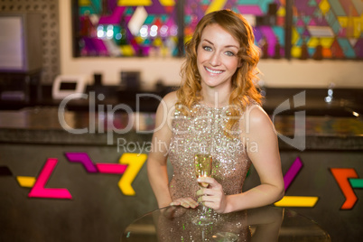 Portrait of young woman holding a glass of champagne