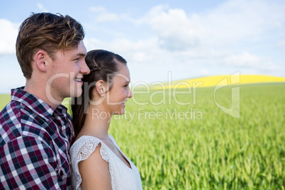 Romantic couple standing in field
