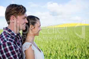Romantic couple standing in field