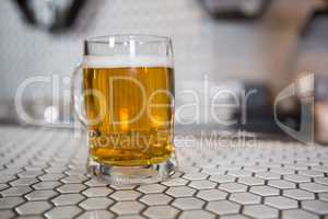Glass of beer on bar counter