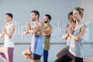 Group of people performing yoga