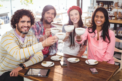 Group of happy friends holding cup of coffee