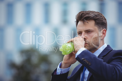 Close-up of businessman drinking juice