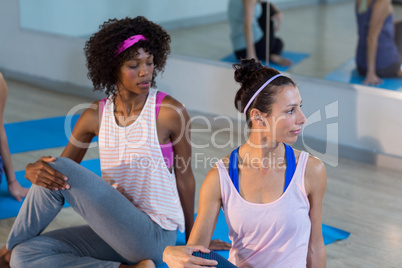 Two women performing yoga