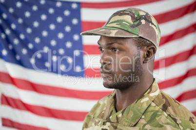 Soldier standing against american flag