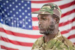 Soldier standing against american flag