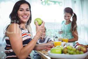 Smiling family having a breakfast