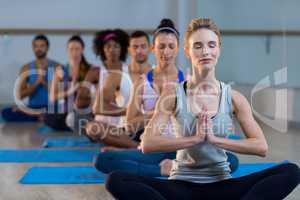 Group of people performing yoga