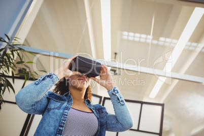 Low angle view of businesswoman enjoying virtual reality headset at office