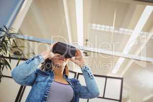 Low angle view of businesswoman enjoying virtual reality headset at office
