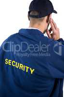 Rear view of security officer listening to earpiece