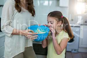 Mother and daughter with bowl of breakfast