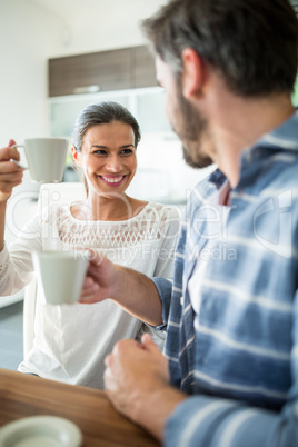 Couple interacting while having coffee