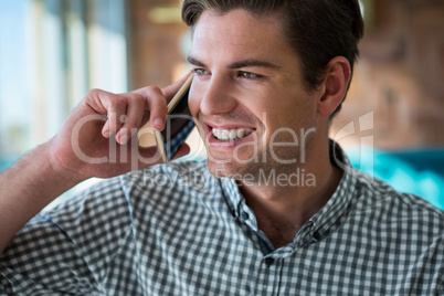 Smiling man talking on the phone