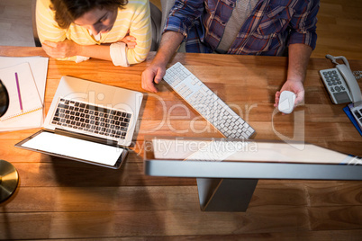 Businesswoman and colleague working on at their desk Businesswoman and colleague working on at their desk