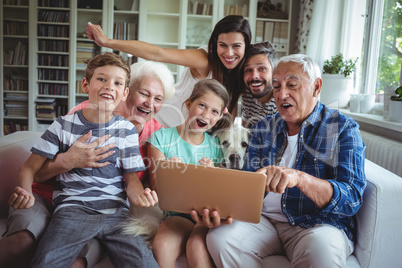 Portrait of happy multi generation using laptop