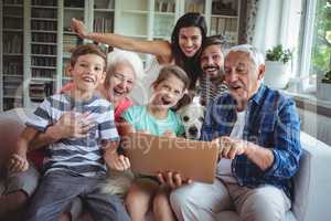 Portrait of happy multi generation using laptop