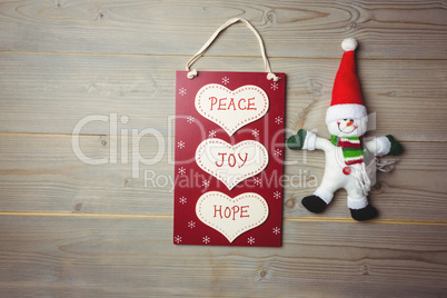 Christmas label with massages and santa claus on wooden table