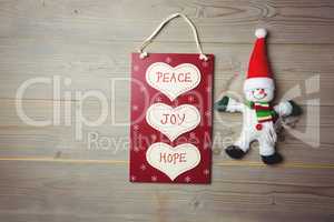 Christmas label with massages and santa claus on wooden table
