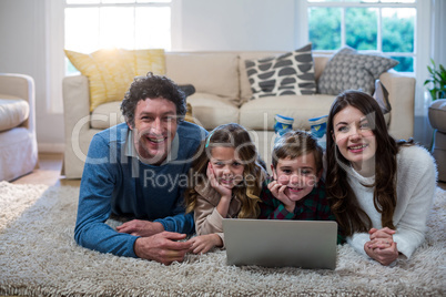 Portrait of family using laptop