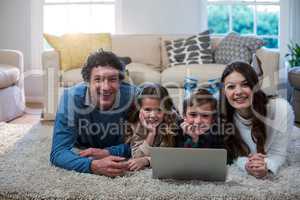 Portrait of family using laptop