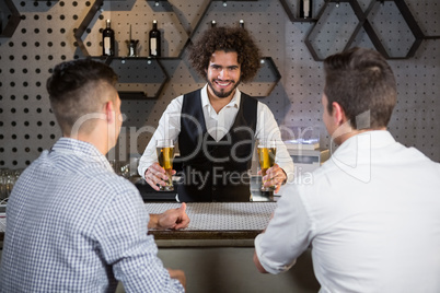 Bartender serving beer to customers