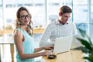 Man and woman using laptop during meeting