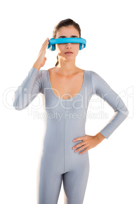 Woman in exercise outfit using virtual video glasses