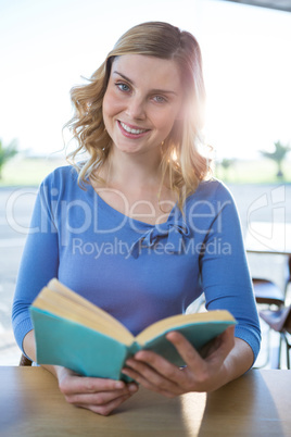 Woman reading a novel in the coffee shop