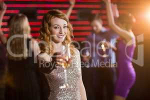 Portrait of young woman holding a glass of champagne