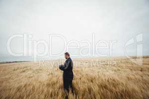 Farmer using digital tablet in the field