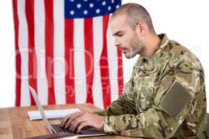 Solider using a laptop at desk