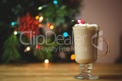 Cup of coffee with marshmallow on wooden table