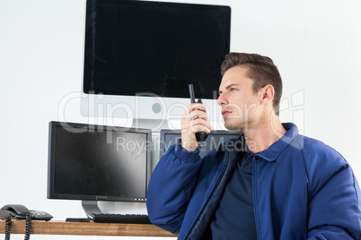 Security officer talking on walkie-talkie