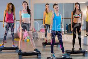Group of women standing on aerobic stepper