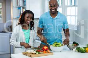 Portrait of couple preparing food