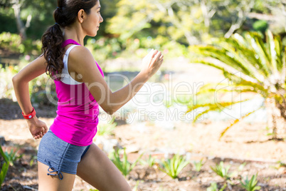 Woman jogging through a forest