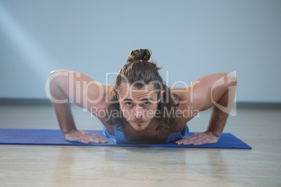 Man doing push-up on exercise mat