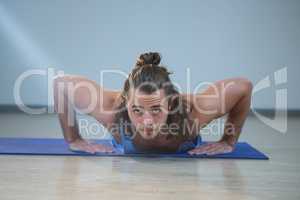 Man doing push-up on exercise mat