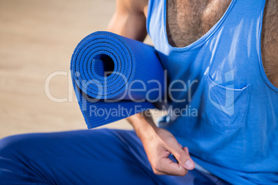 Man holding exercise mat