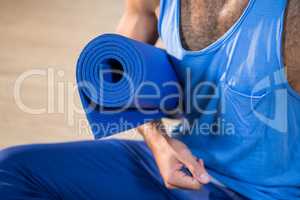 Man holding exercise mat