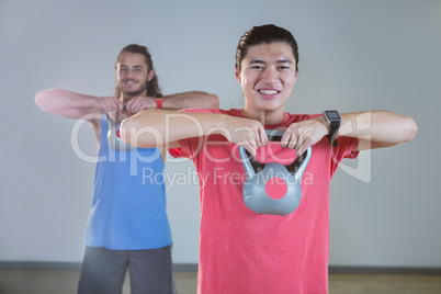 Men exercising with kettlebell