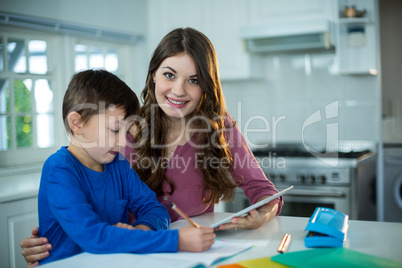 Mother helping her son with homework