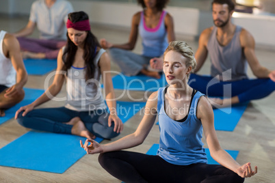 Group of people performing yoga