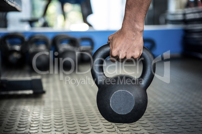 Cropped image of person holding kettlebell