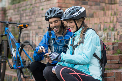 Biker couple using mobile phone