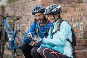 Biker couple using mobile phone