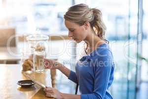 Woman using digital tablet in cafÃ?Â©