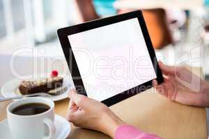 Woman holding a digital tablet in the coffee shop