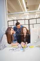 Business people using computer in meeting room